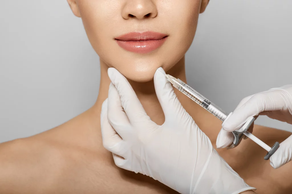 Doctor injecting dermal fillers for chin